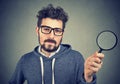 Curious man investigating with magnifier Royalty Free Stock Photo