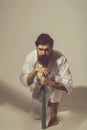 Bearded serious karate man in kimono with green baseball bat Royalty Free Stock Photo