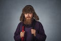 Serious man in fur hat dressed in a pullover holding red scarf posing Royalty Free Stock Photo