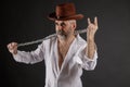 Bearded short-haired elderly man with a metal chain in his hands shows a rockers goat