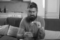 Bearded sick man throws a pill of flu in a glass water.