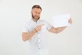 Bearded smiling businessman demonstrating empty blank sheet paper. Mock up, place for text. Promotion career. Copy space Royalty Free Stock Photo