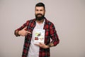 Bearded smiling man in checkered shirt pointing at digital tablet with ebay app, isolated Royalty Free Stock Photo