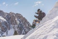 Bearded smiling snowboarded taking rest after ride session.Young man chilling on top of the snow mountain. Blurred Royalty Free Stock Photo