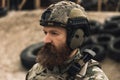 Bearded soldier in military uniform looking determined and serious