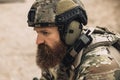 Bearded soldier in military uniform looking determined and serious
