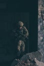 A bearded soldier in uniform of special forces in a dangerous military action in a dangerous enemy area. Selective focus Royalty Free Stock Photo