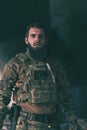 A bearded soldier in uniform of special forces in a dangerous military action in a dangerous enemy area. Selective focus Royalty Free Stock Photo