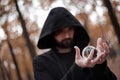 Bearded sorcerer conjures with a magic ball