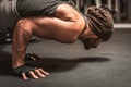 A bearded sporty man in the gym is doing Yoga exercises. Position on arms. Yoga mental benefits. Royalty Free Stock Photo