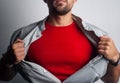 A bearded superhero tears his shirt
