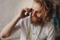 Bearded tailor talking on phone