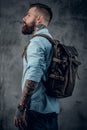 Bearded tattooed man in the studio