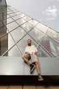 Bearded tattooed hipster posing in front of office building Royalty Free Stock Photo