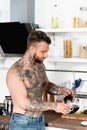 Bearded, man pouring coffee while standing