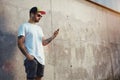 Bearded and tattooed young man holding his smartphone Royalty Free Stock Photo