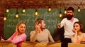 Bearded teacher, lecturer, professor watching students during test, exam, lesson. Cheat on test concept. Students, group Royalty Free Stock Photo