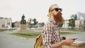 Bearded tourist man lost in city and using smartphone online map to find right directions Royalty Free Stock Photo