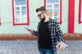 Bearded tourist man lost in city and using smartphone online map to find right directions. Travel and trip concept. Royalty Free Stock Photo