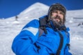 Bearded trekker resting while climbing in winter Royalty Free Stock Photo