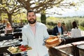 Bearded waiter inviting on outdoor terrace Royalty Free Stock Photo