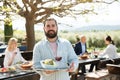 Bearded waiter inviting on outdoor terrace Royalty Free Stock Photo