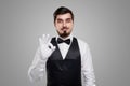 Bearded waiter in uniform gesturing OK Royalty Free Stock Photo