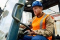 Bearded worker driving lift truck Royalty Free Stock Photo