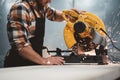 Bearded worker mechanic using electrical angular grinding machine in metalworking plant. Work in action. Sparks fly apart Royalty Free Stock Photo