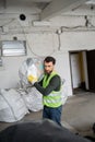 Bearded worker in protective vest and