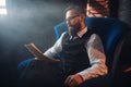 Bearded writer in glasses reads handwritten text Royalty Free Stock Photo