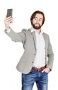 bearded young business man taking selfie smiling. portrait isolated over white studio background. Royalty Free Stock Photo