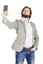 bearded young business man taking selfie smiling. portrait isolated over white studio background. Royalty Free Stock Photo