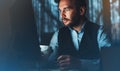 Bearded young businessman working on modern office. Consultant man thinking looking in monitor computer. Manager typing on keyboar Royalty Free Stock Photo