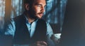 Bearded young businessman working on modern office. Consultant man thinking looking in monitor computer. Manager typing on keyboar Royalty Free Stock Photo