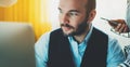 Bearded young businessman working on modern office at night. Consultant man thinking looking in monitor computer. Manager typing o Royalty Free Stock Photo