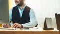 Bearded young businessman working on modern office at night. Consultant man thinking looking in monitor computer. Manager typing o Royalty Free Stock Photo