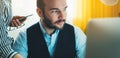 Bearded young businessman working on modern office at night. Consultant man thinking looking in monitor computer. Manager typing o Royalty Free Stock Photo