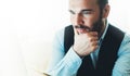 Bearded young businessman working on modern office at night. Consultant man thinking looking in monitor computer. Manager typing