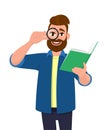 Bearded young man looking through magnifying glass or magnifier and holding book. Hipster person reading and looking from loupe. Royalty Free Stock Photo