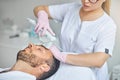 Bearded young man receiving laser facial treatment
