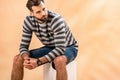 Bearded young man in striped sweatshirt sitting Royalty Free Stock Photo