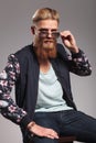 Bearded young man takes off sunglasses Royalty Free Stock Photo