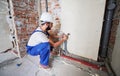 Man plumber installing heating system in apartment. Royalty Free Stock Photo