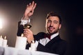 beardman gesturing and holding glass of wine in restaurant