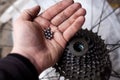 Bearing balls in hand. Rear bicycle cog cassette bearing maintenance required close-up. Ready for repair, clean and lubricating Royalty Free Stock Photo