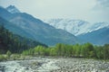 Beas river on a background himalayan snow mountains and white clouds