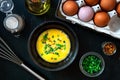 Beat eggs in a bowl, and ingredients for making an omelette with green onions