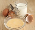 Beat eggs with milk in a glass bow Royalty Free Stock Photo