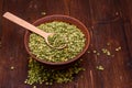 Beat green peas dry in a bowl with a wooden spoon on a wooden background.
